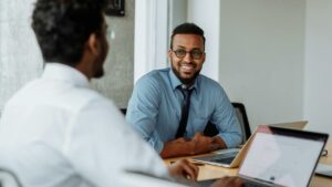 Happy HR hiring managers showing how to increase efficiency and reduce time-to-hire with online background checks