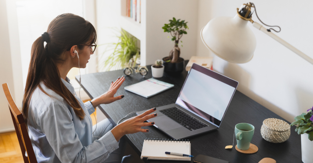 female employee at desk video call remote work 1