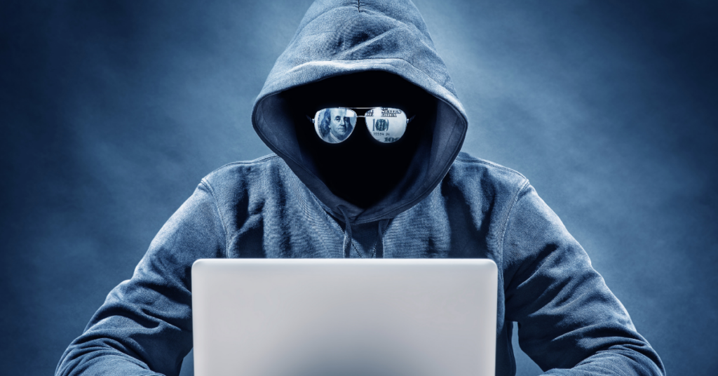 Person with Mask and Sunglasses on Computer Committing Fraud 