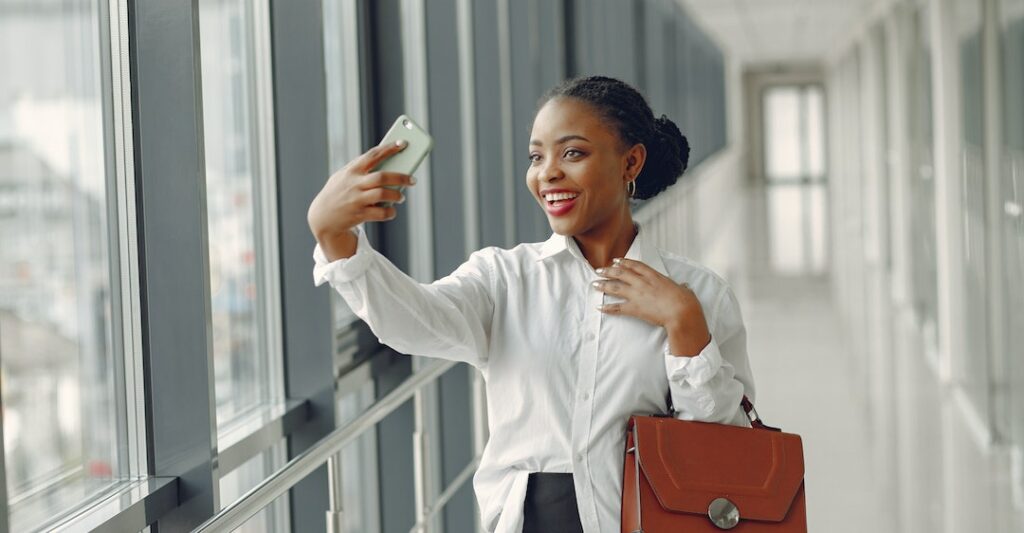 Female employee completing international background checks on her cellphone